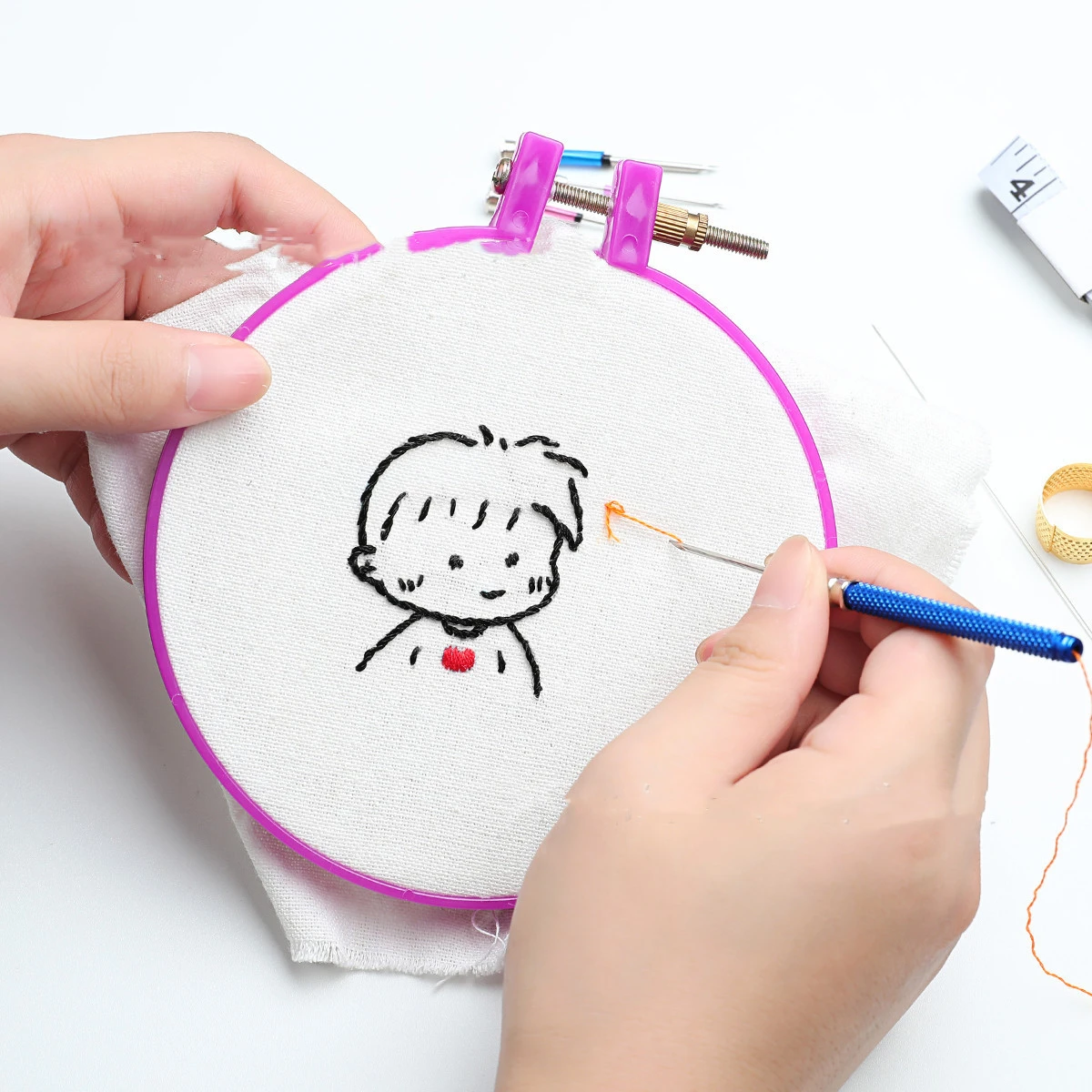 Embroidery needles with interchangeable heads