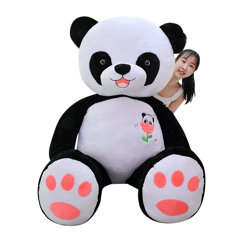 Black and white giant panda hugging panda plush toy