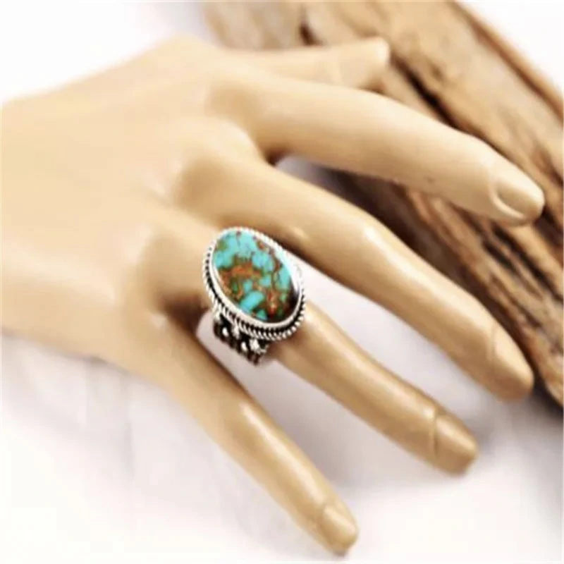 Female Hand Metal Inlaid Turquoise Ring