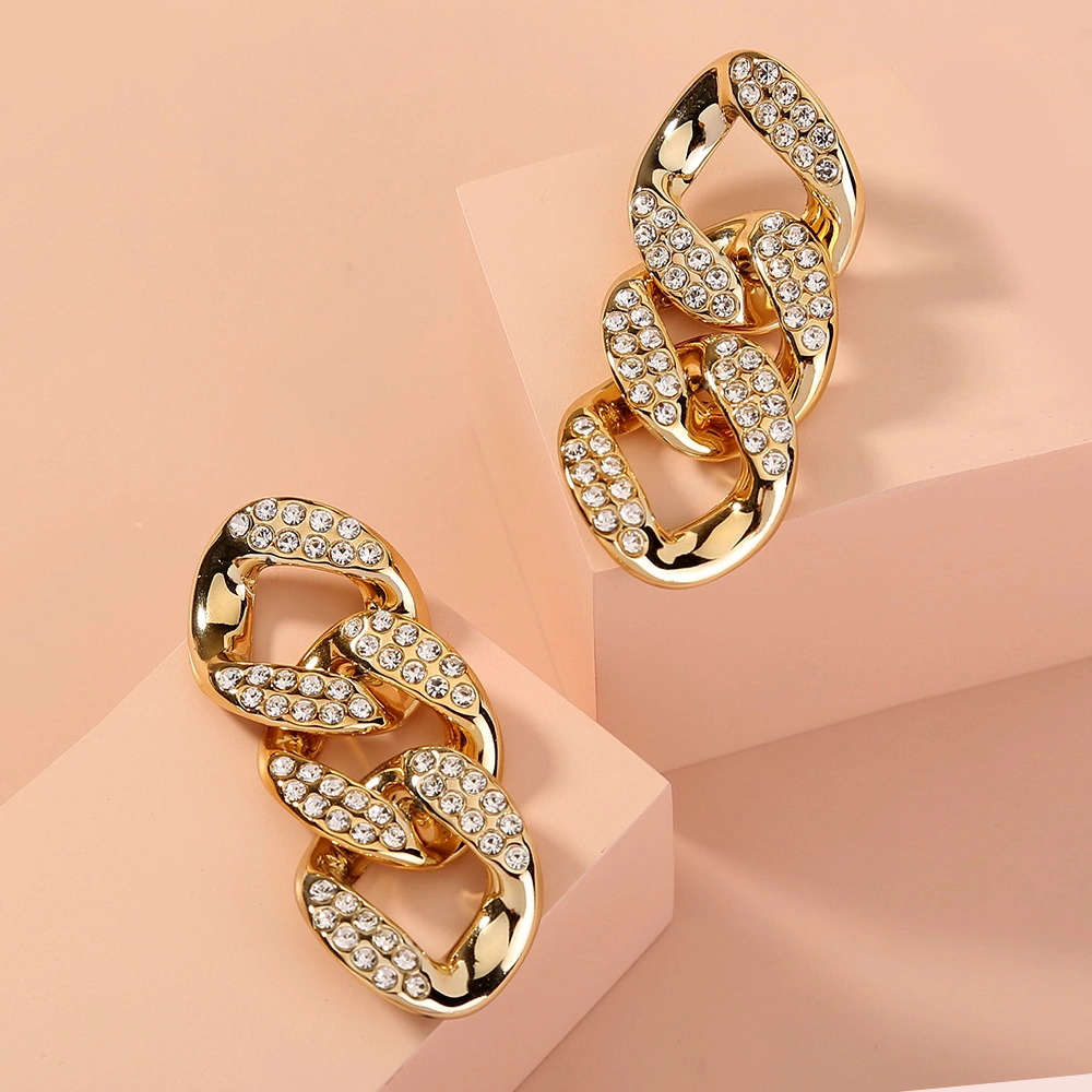 Exaggerated studs with short chains and diamond studs