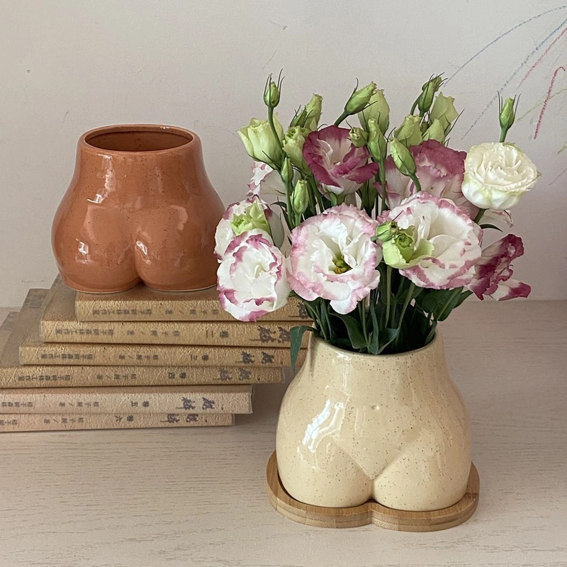 An Ornamental Ceramic Vase In The Shape Of A Human Hip