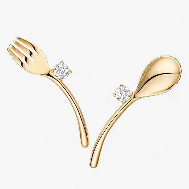 Golden cutlery and diamond earrings