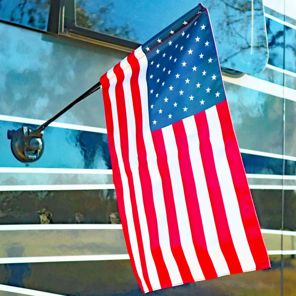 The Traveler RV Flag Pole Kit. Includes12"x18" Inch Flag, 24” Inch Flag Pole With Adjustable Angle Suction Cup Mount And Storage Bag.