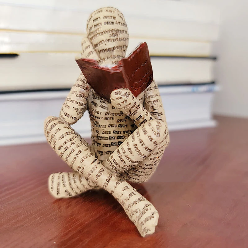 A Woman Reading A Paper Pulp Molding Ornament Tree