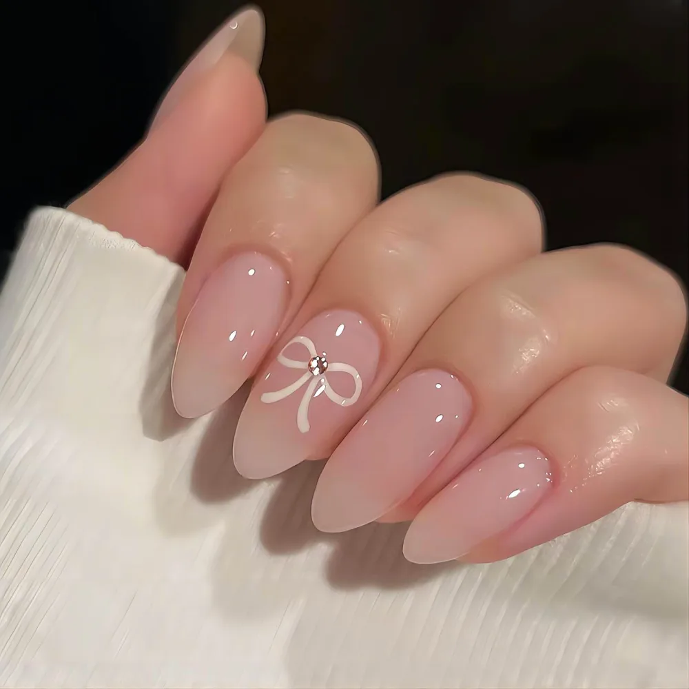 Pink Almond Press on Nails Medium Length Fake Nails Acrylic False Nails with White Bow Designs Glossy Artificial Nail Press ons Reusable Natural Stick on Nails for Women 24Pcs