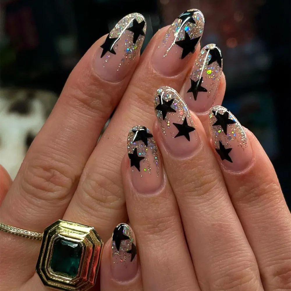 Press on Nails Medium Pointed Almond Fake Nails with Black Five-pointed Star Glitter Powder Designs Full Cover Y2K Acrylic Nails Glue on Nails Glossy Nude False Nails for Women Girls 24 Pcs