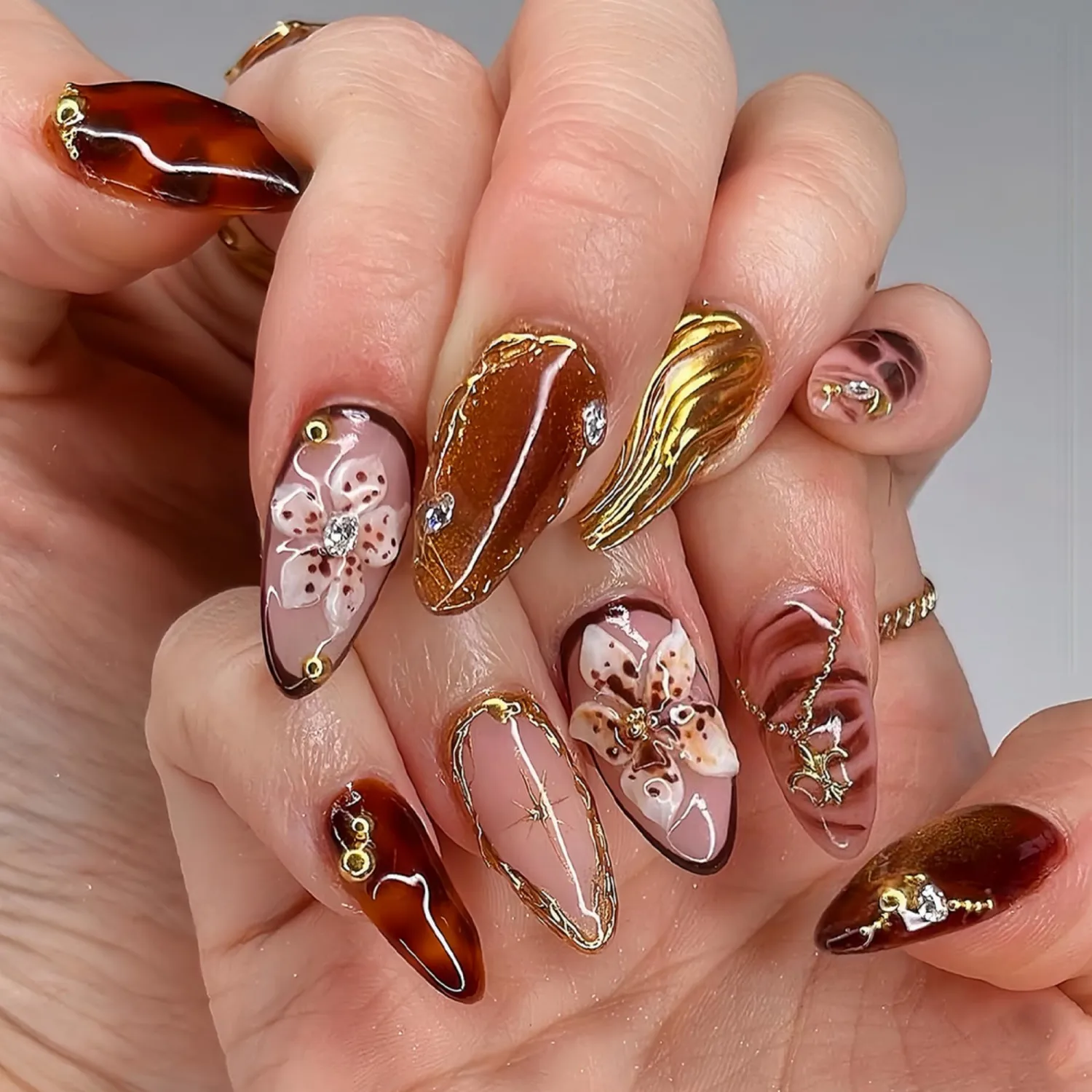 Medium Almond Press on Nails Brown Fake Nails Floral Artificial Nail with Gold Charm Designs Glitter Stick on Nail for Women 24pcs