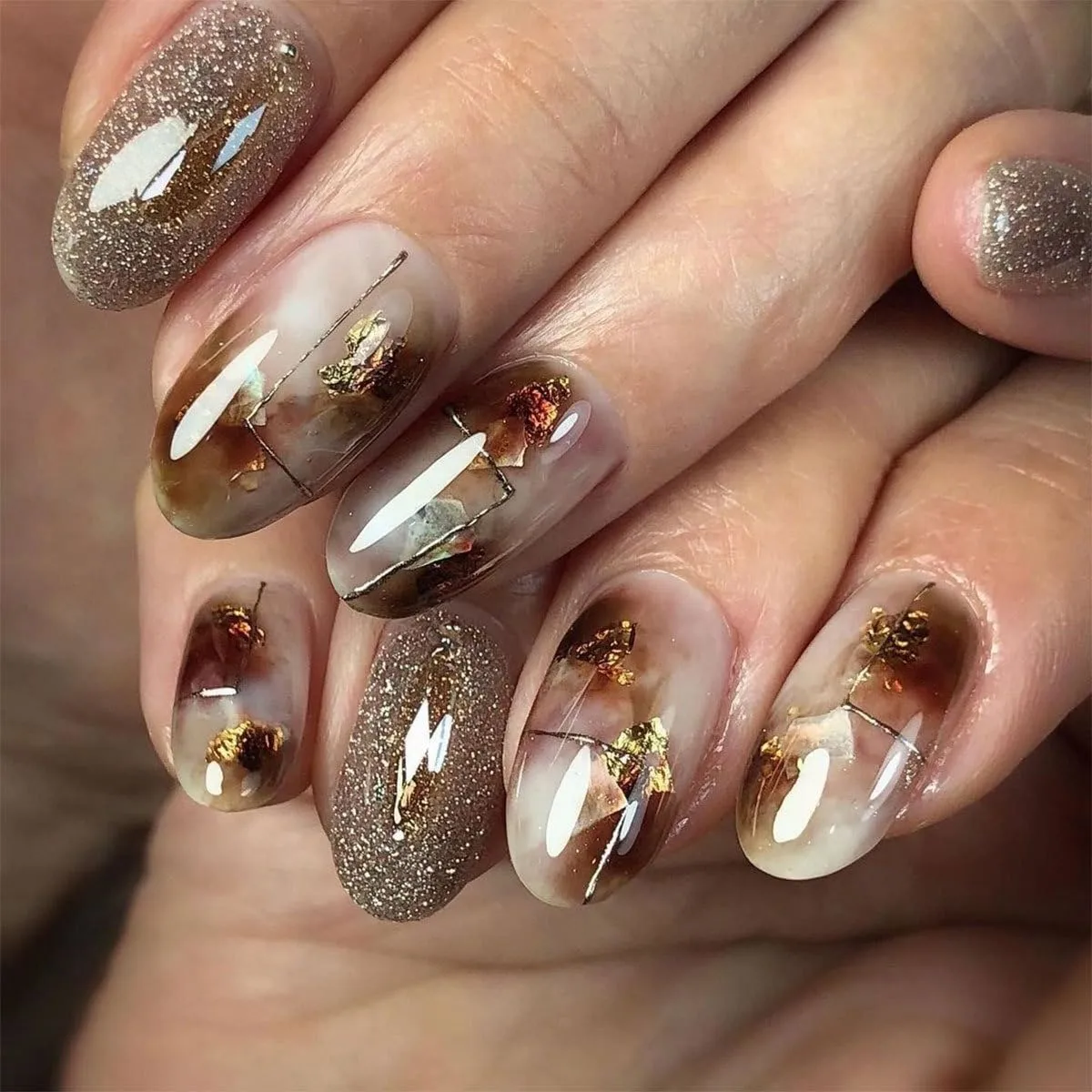 Brown Marble Press on Nails Medium Oval Glossy Fake Nails with Glitter and Gold Foil Designs Natural Reusable Acrylic Nails Full Cover Artificial Nail Kit for Women and Girls 24 Pcs